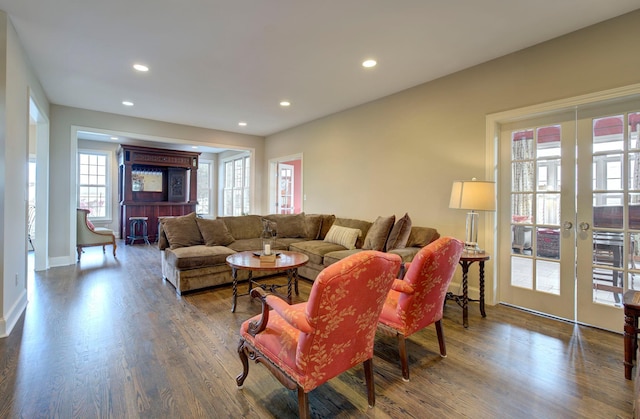 living room with recessed lighting, baseboards, wood finished floors, and french doors