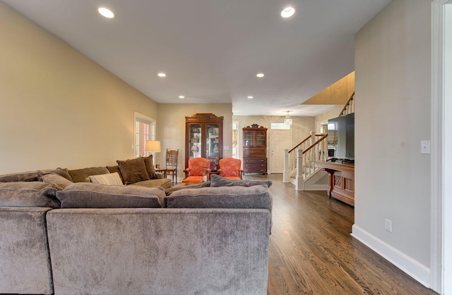 living area with recessed lighting, dark wood-style flooring, stairway, and baseboards