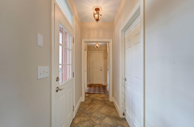 doorway to outside featuring baseboards