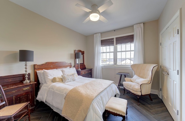 bedroom with ceiling fan, a closet, and dark wood-type flooring