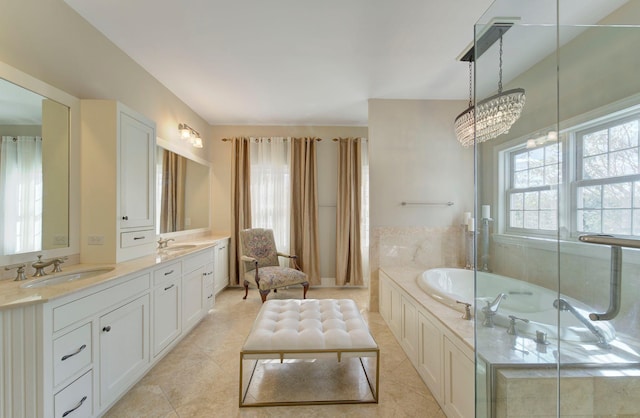 full bath with tile patterned floors, a garden tub, a sink, and double vanity