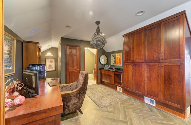 office space with visible vents and vaulted ceiling