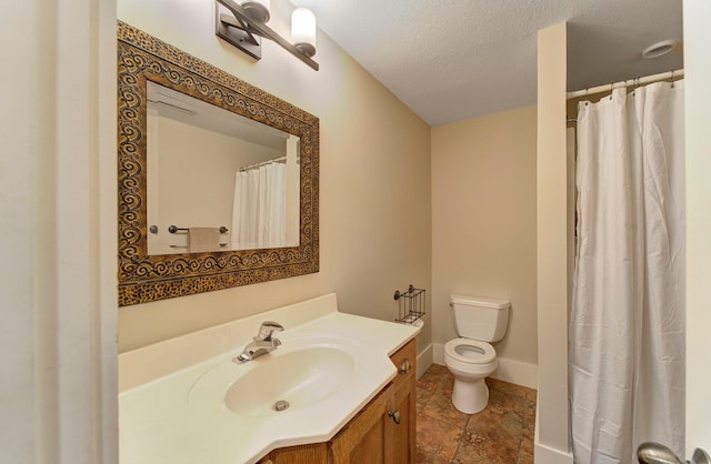 full bathroom with toilet, baseboards, a textured ceiling, and vanity