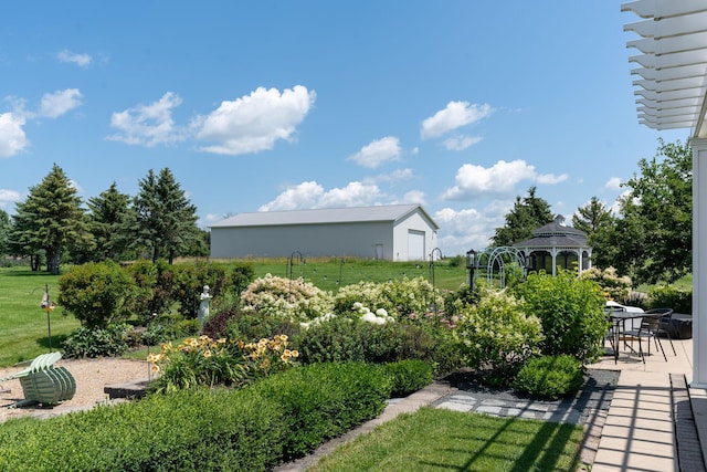 view of community with a gazebo, a patio, and a lawn