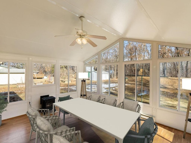 sunroom featuring vaulted ceiling with beams, a healthy amount of sunlight, and ceiling fan