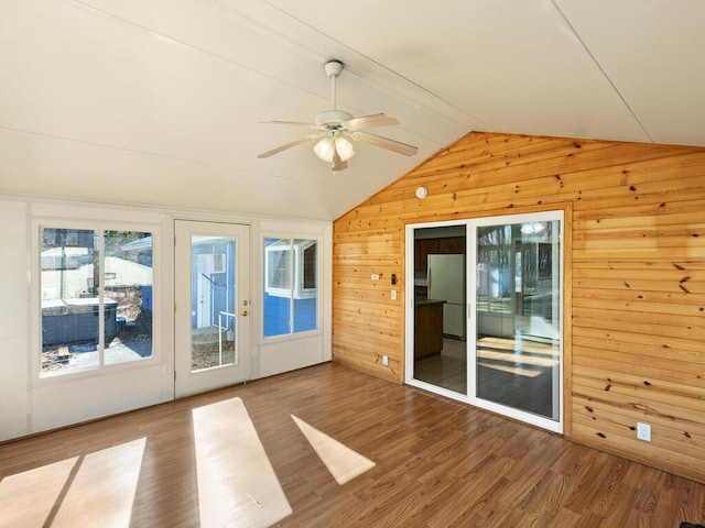 unfurnished sunroom featuring a ceiling fan and lofted ceiling