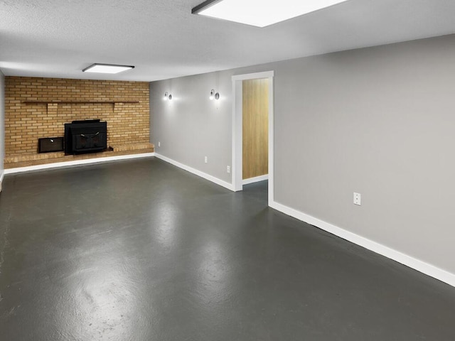 unfurnished living room featuring concrete flooring, a textured ceiling, a wood stove, and baseboards