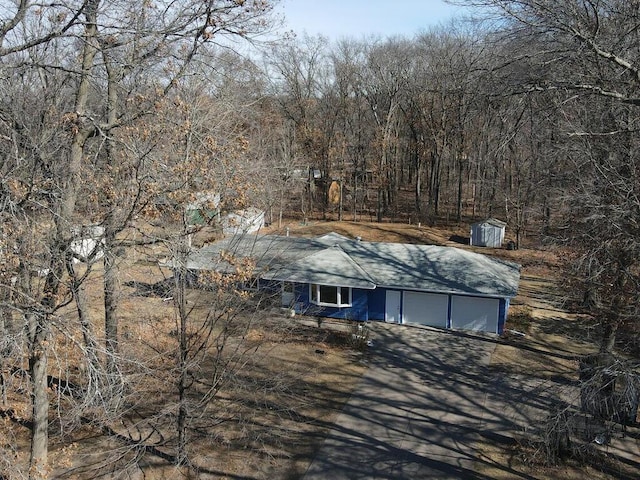 exterior space featuring a wooded view