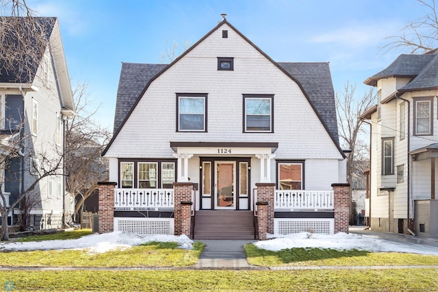 view of front of house featuring a shingled roof, a porch, and a gambrel roof