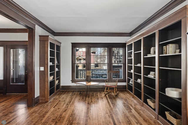 unfurnished room featuring hardwood / wood-style flooring and crown molding