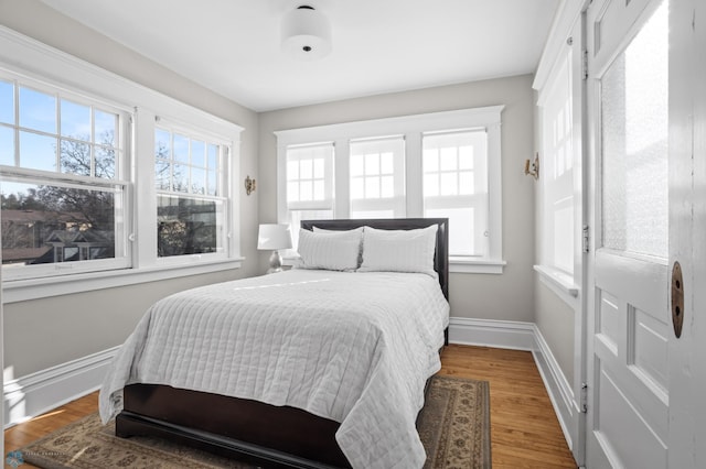 bedroom featuring baseboards and wood finished floors