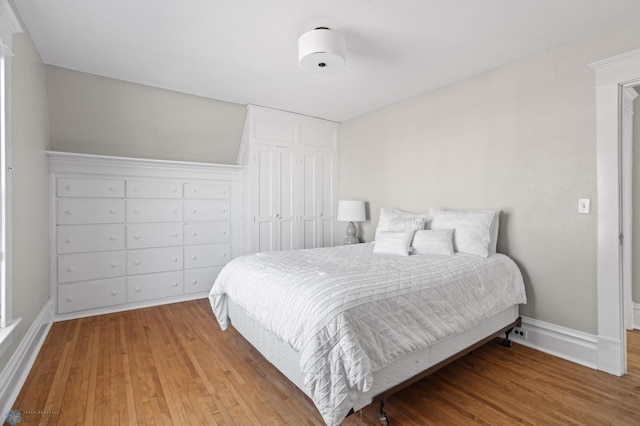 bedroom featuring wood finished floors and baseboards