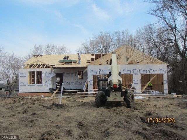 rear view of house featuring roof with shingles