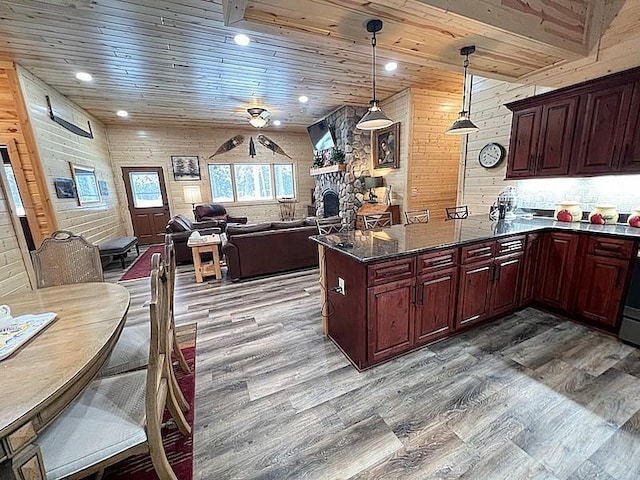 kitchen with a peninsula, wooden ceiling, and wood finished floors