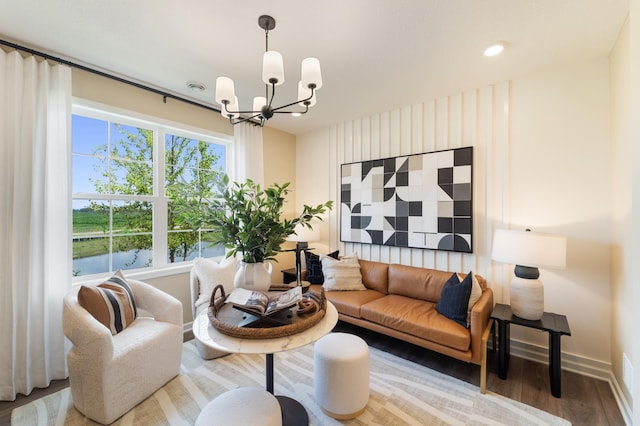 living area featuring baseboards, a chandelier, wood finished floors, and recessed lighting