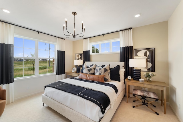 bedroom featuring baseboards, multiple windows, and an inviting chandelier