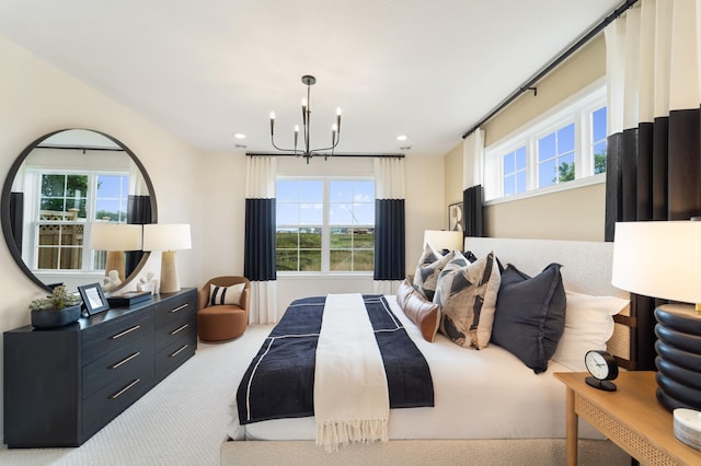 carpeted bedroom with a chandelier and recessed lighting