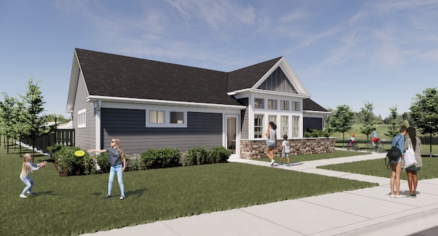 view of front of property with roof with shingles, a front yard, board and batten siding, and fence