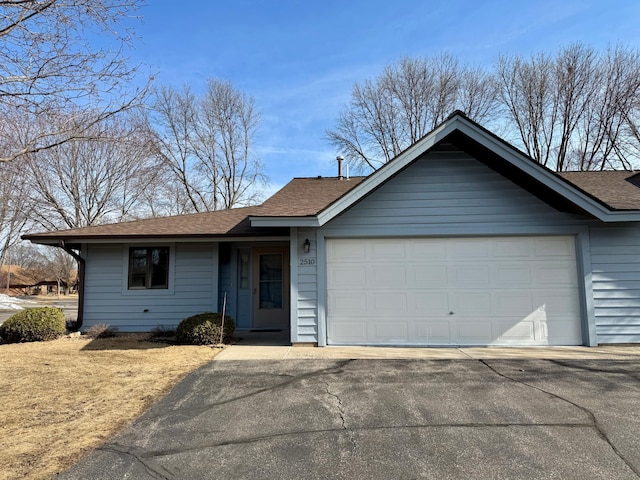 single story home featuring driveway and an attached garage