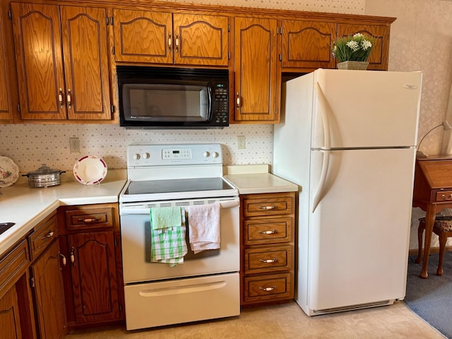 kitchen featuring brown cabinets, white appliances, light countertops, and backsplash