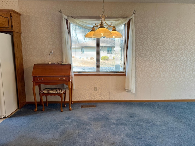 carpeted dining area with wallpapered walls, baseboards, and visible vents