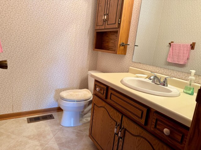 bathroom featuring vanity, tile patterned floors, visible vents, and wallpapered walls