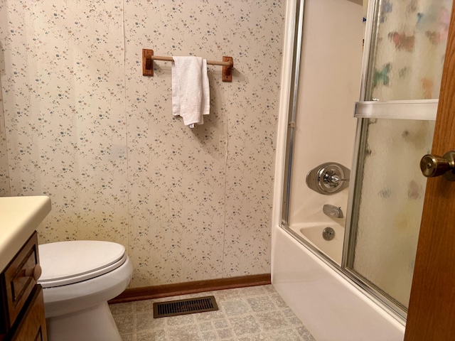 full bathroom featuring bath / shower combo with glass door, visible vents, toilet, tile patterned flooring, and baseboards