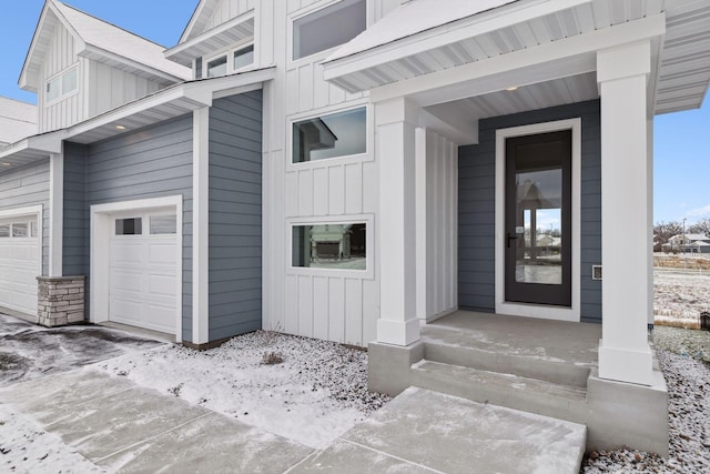 entrance to property featuring a garage and board and batten siding