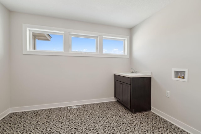 bathroom featuring baseboards and vanity