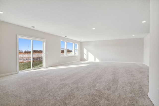 carpeted empty room with recessed lighting and baseboards