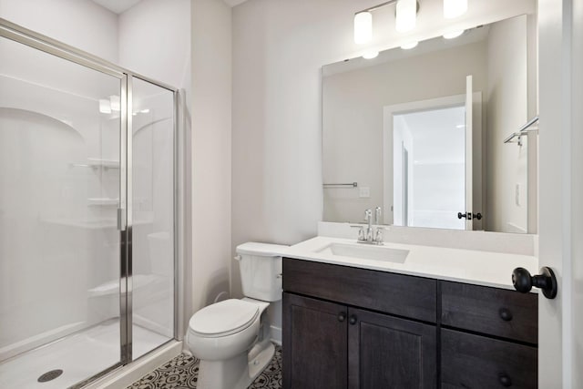 bathroom with vanity, a shower stall, and toilet