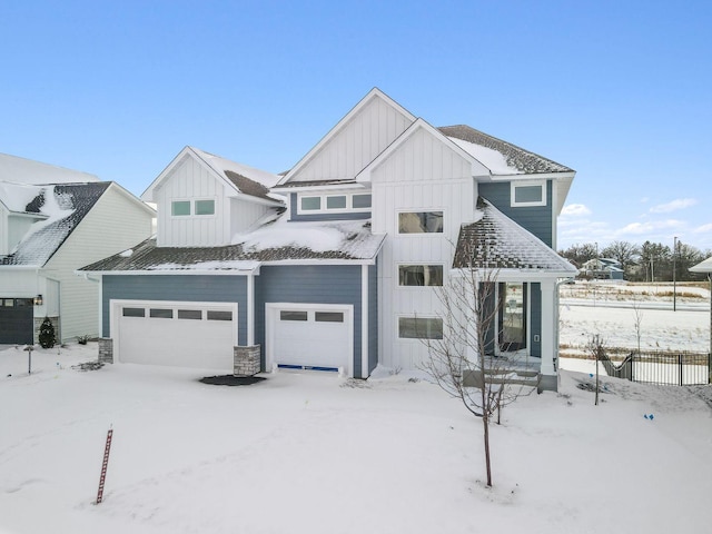 view of front of property featuring board and batten siding, an attached garage, fence, and central air condition unit