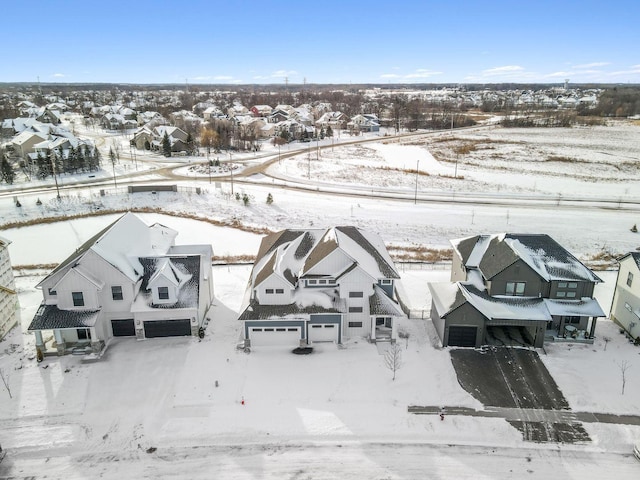 snowy aerial view with a residential view