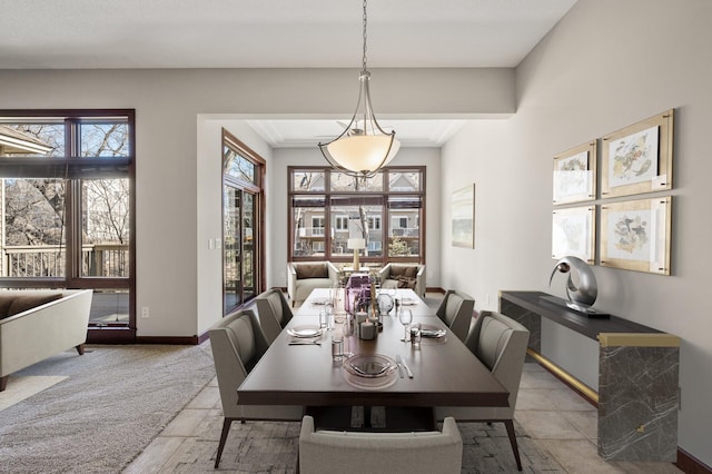 dining area with crown molding, plenty of natural light, and baseboards