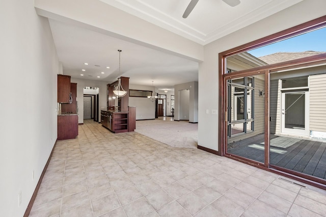 unfurnished living room with recessed lighting, visible vents, baseboards, and ceiling fan with notable chandelier