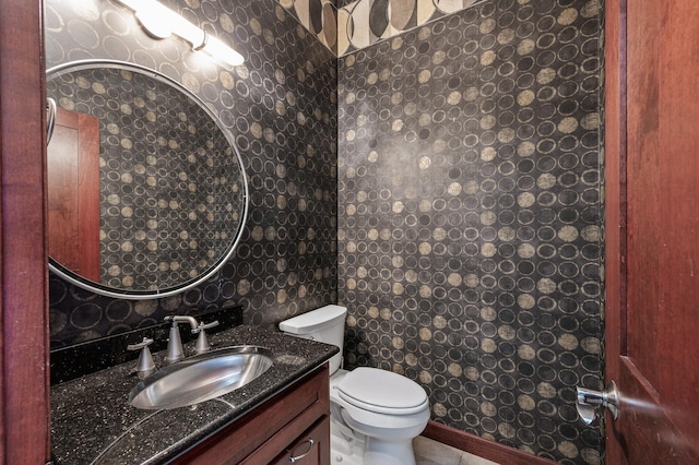 half bath with vanity, tile patterned flooring, tile walls, toilet, and backsplash