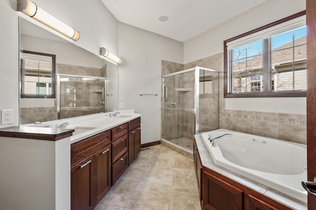 bathroom with tile patterned flooring, a shower stall, double vanity, and a sink