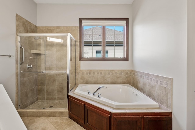 full bathroom featuring tile patterned flooring, a bath, and a stall shower