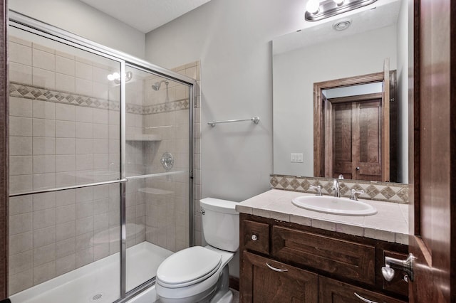 full bathroom with vanity, toilet, a stall shower, and backsplash