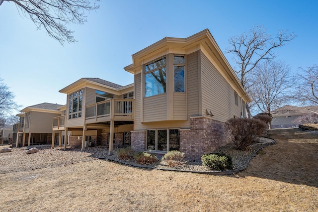 rear view of house with brick siding