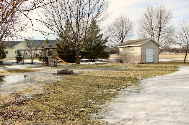 view of yard with a playground and an outbuilding