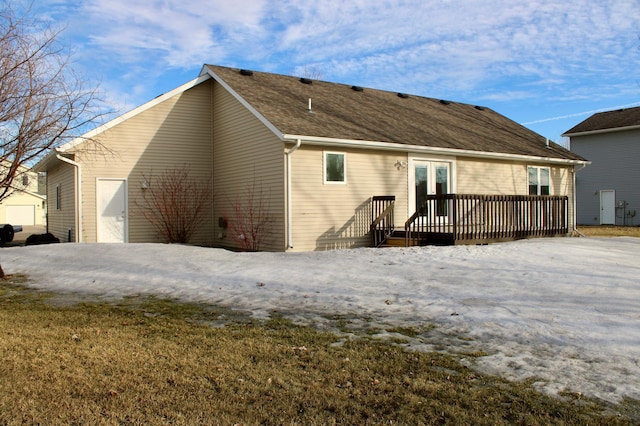 rear view of property with a shingled roof, french doors, and a wooden deck