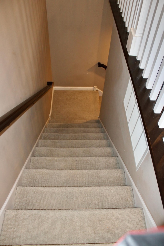 stairway with carpet and baseboards