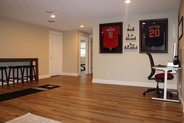 interior space featuring recessed lighting, wood finished floors, and baseboards