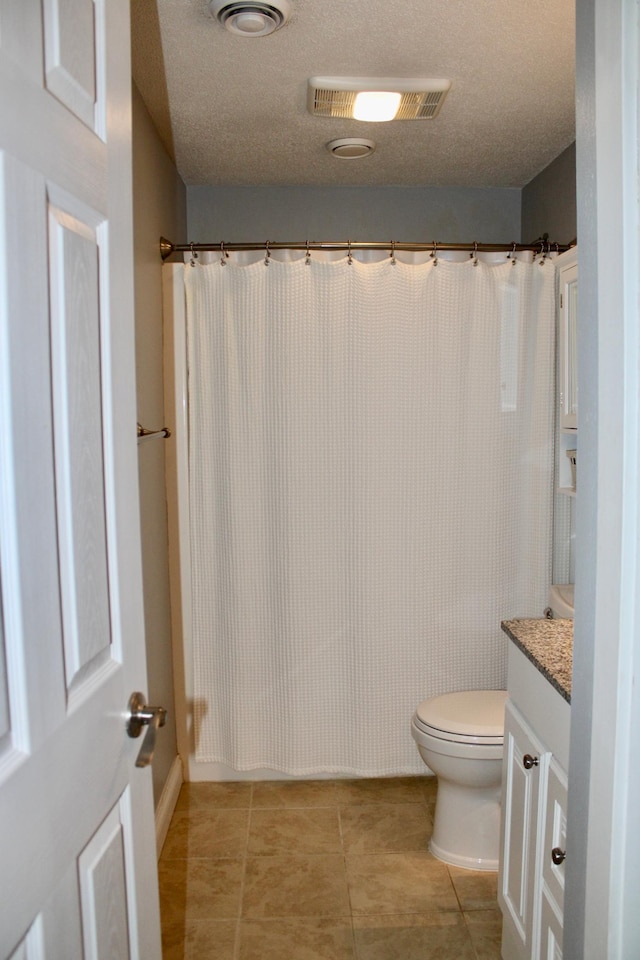 bathroom featuring visible vents, toilet, tile patterned floors, a textured ceiling, and vanity