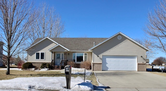 single story home with a garage, brick siding, driveway, and a shingled roof