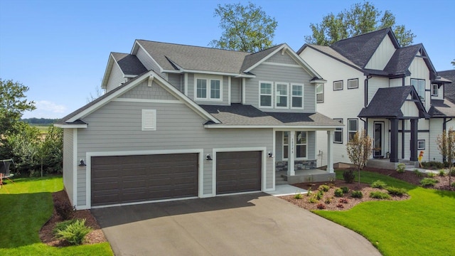 view of front of property featuring a shingled roof, a front yard, driveway, and a garage