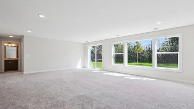 unfurnished room with light carpet, baseboards, and recessed lighting