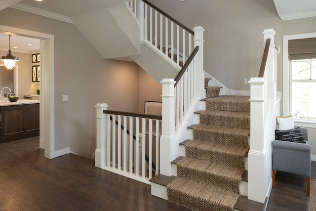 stairs featuring crown molding, wood finished floors, baseboards, and recessed lighting