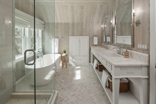 bathroom featuring a freestanding bath and double vanity